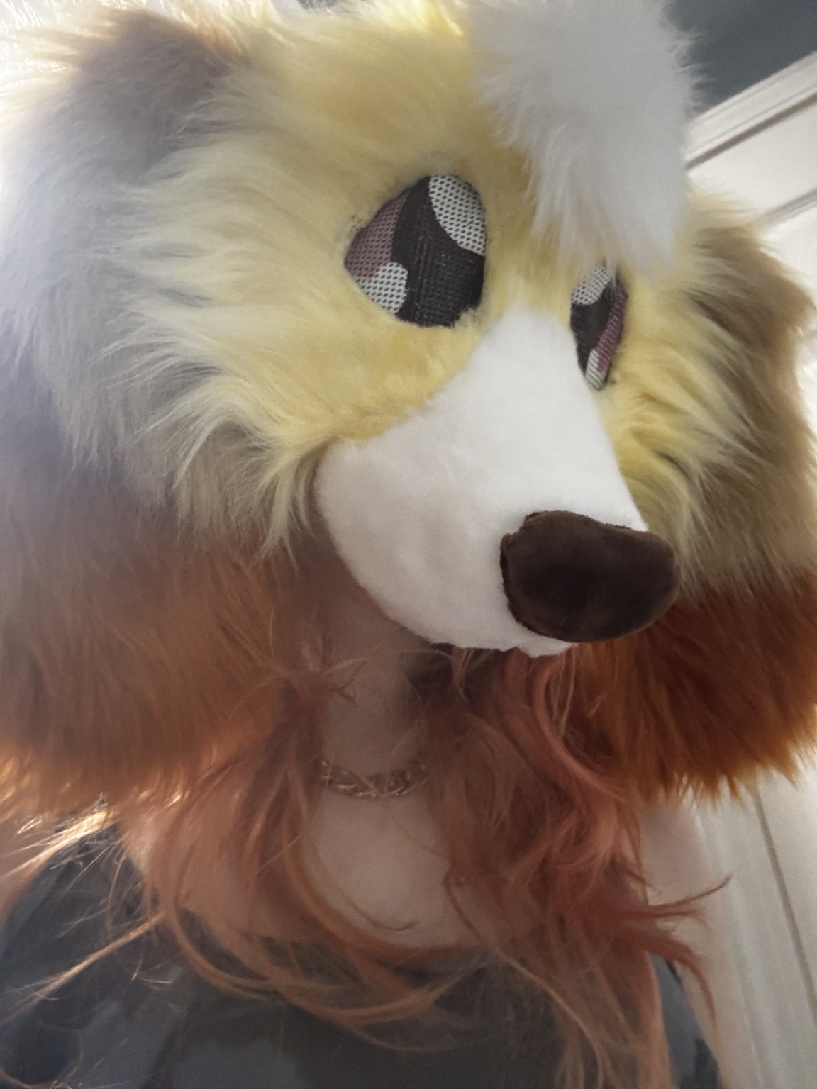 Cream and brown creature mask being worn