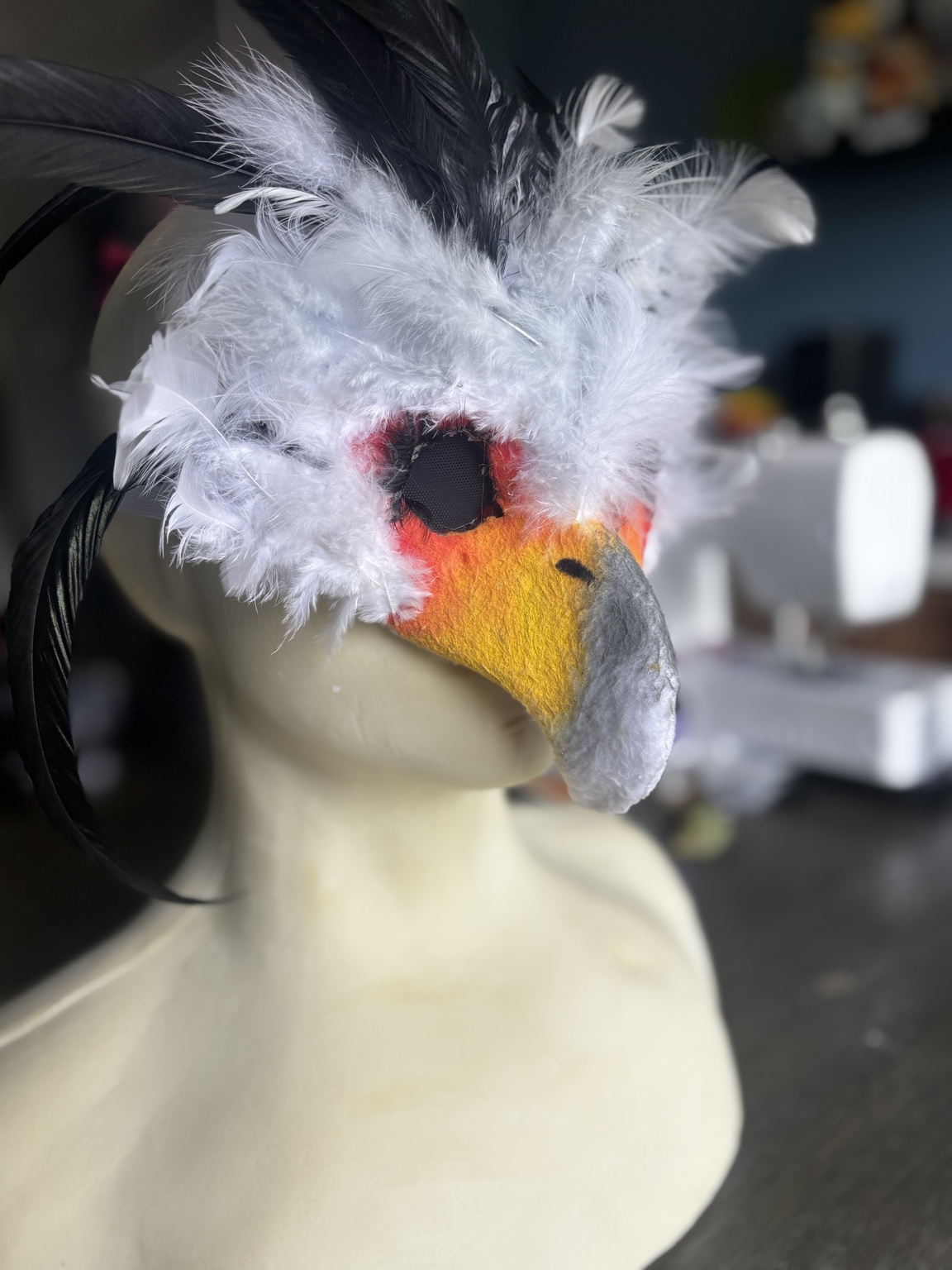 White feathered secretary bird mask with black plumes