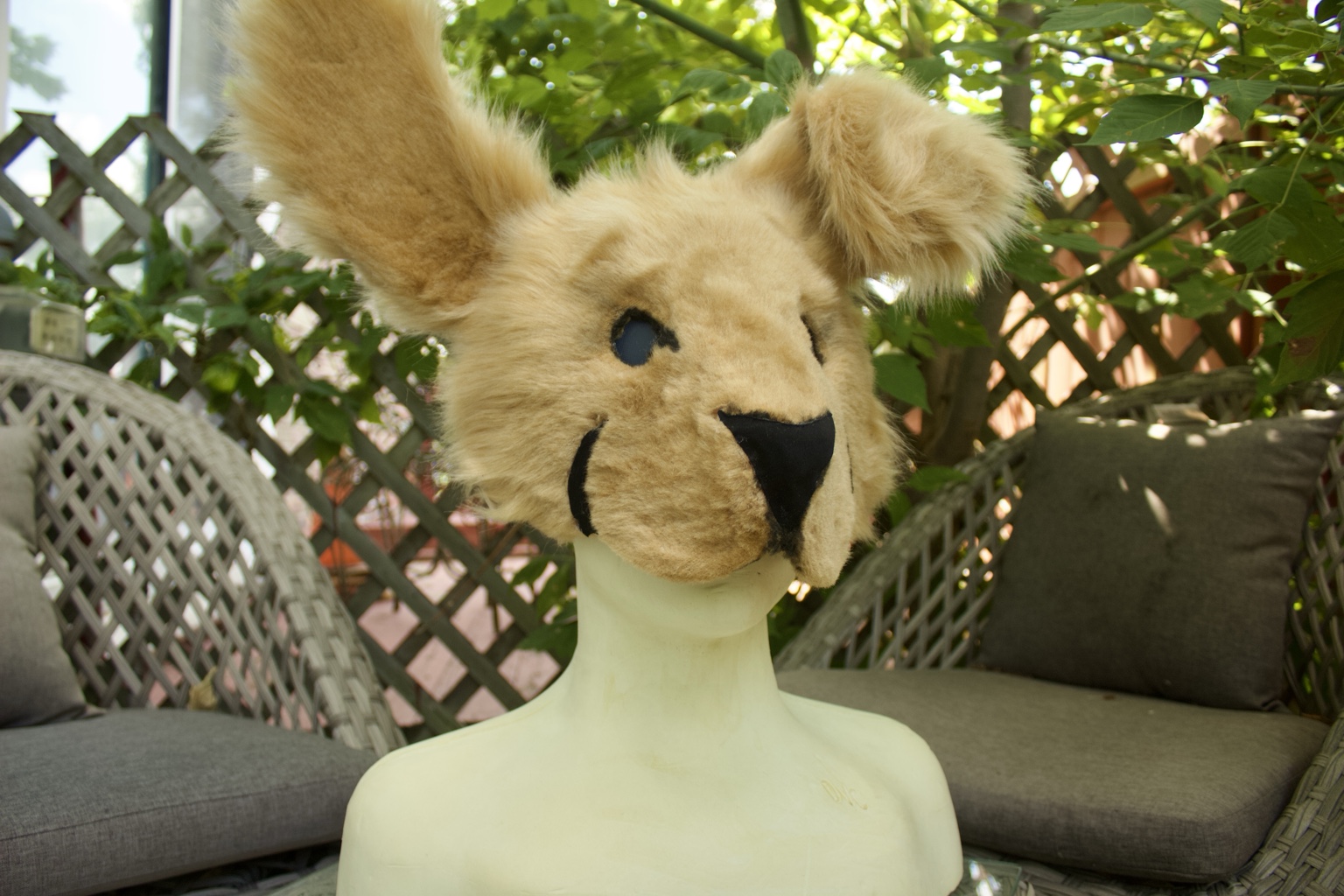 Tan creature mask with mismatched ears